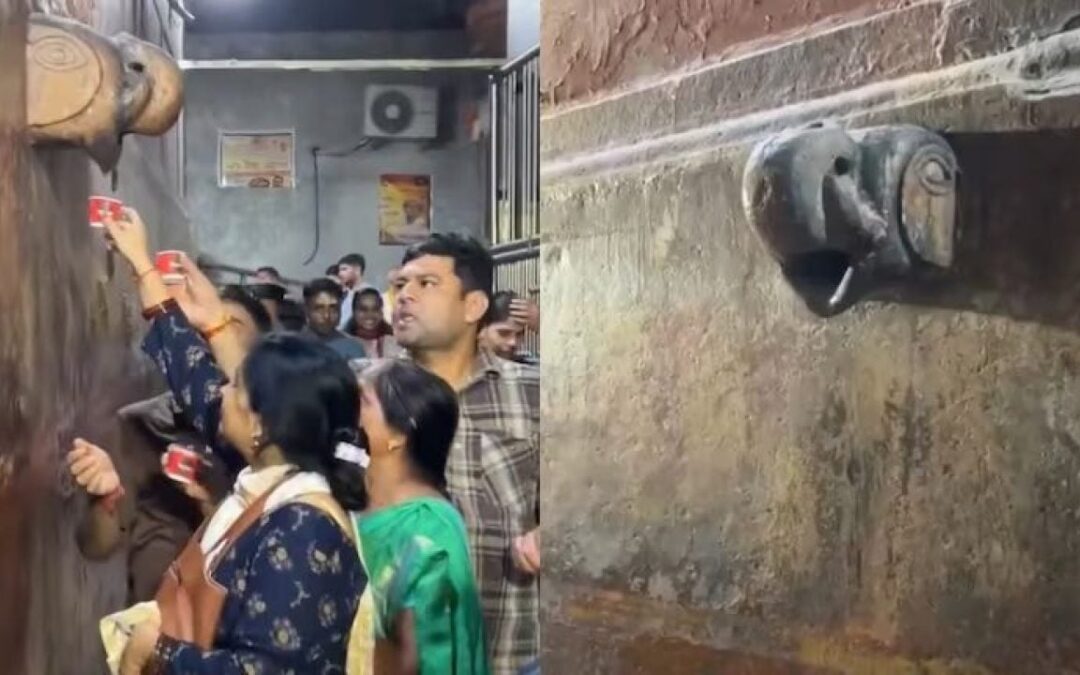 Devotees offer milk to temple wall figure.