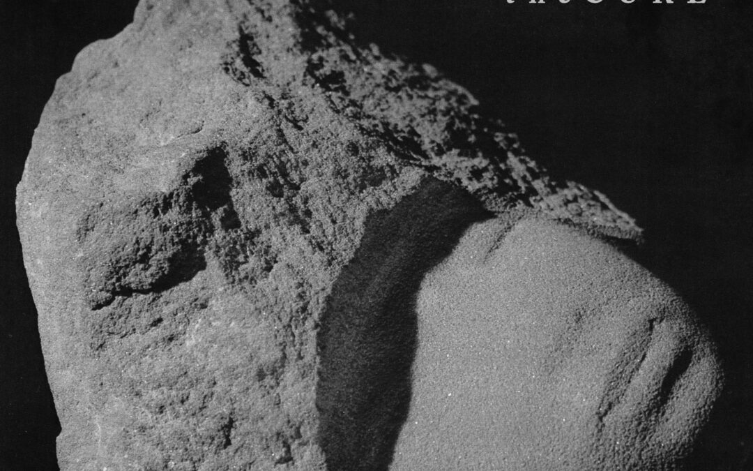 The Cure album cover with sand and rock sculpture.