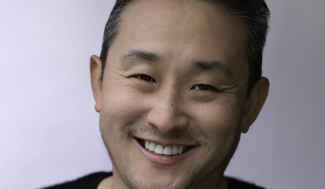 Smiling person with short hair in close-up portrait