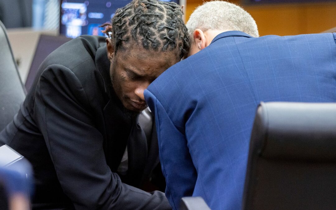Two men discussing in courtroom