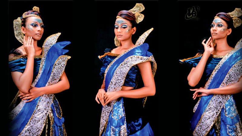 Model in blue futuristic outfit posing uniquely.